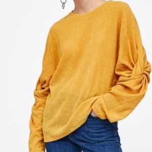 Mustard yellow Top with sleeve detail.
